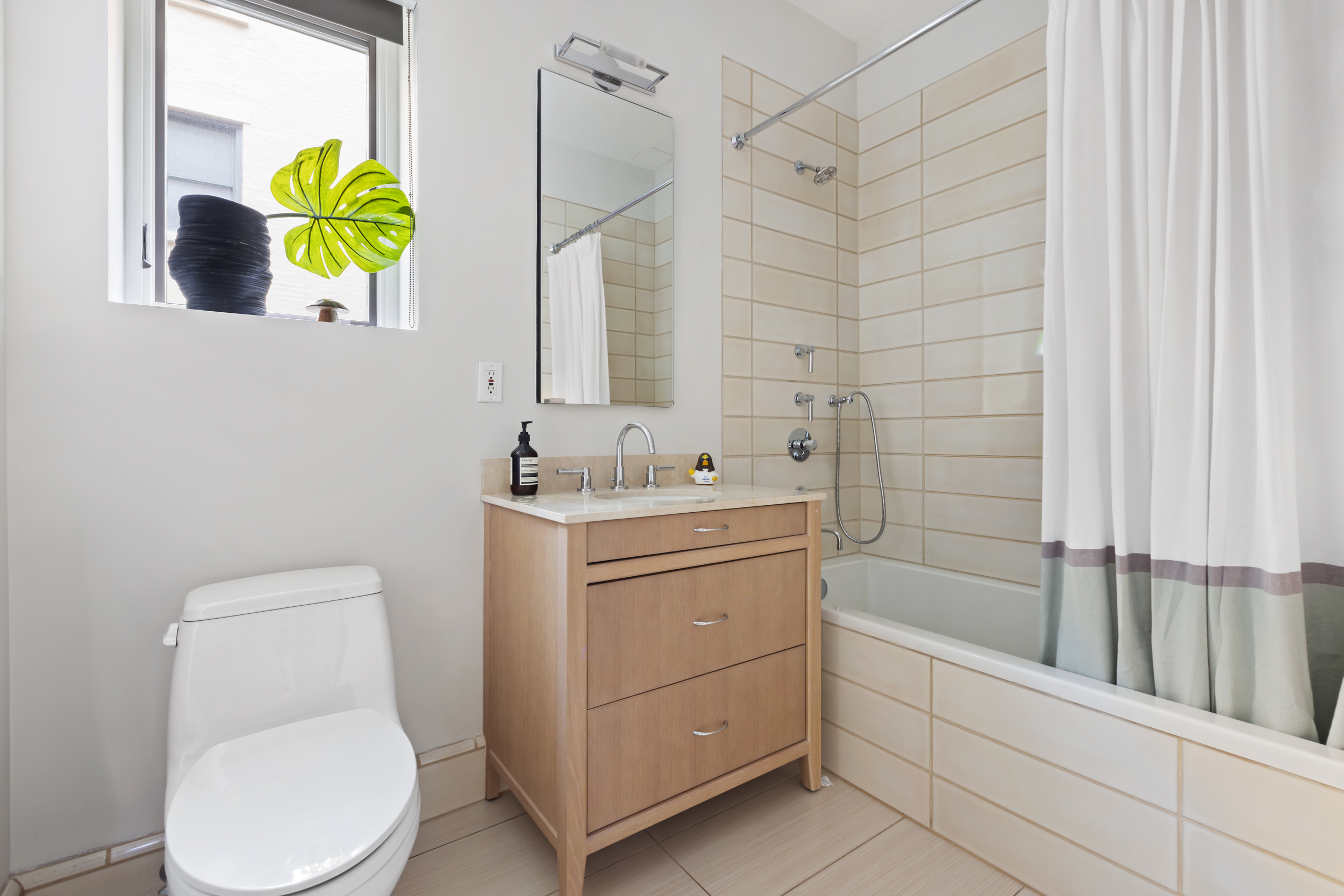 95 Charles Street, Unit TH Manhattan, NY 10014 - Photo 21 of 29 a bathroom with a sink a toilet and shower