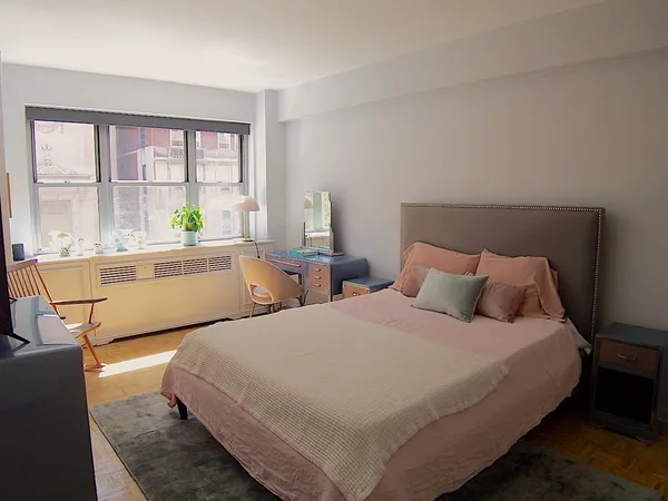 a bed room with two beds and a large window