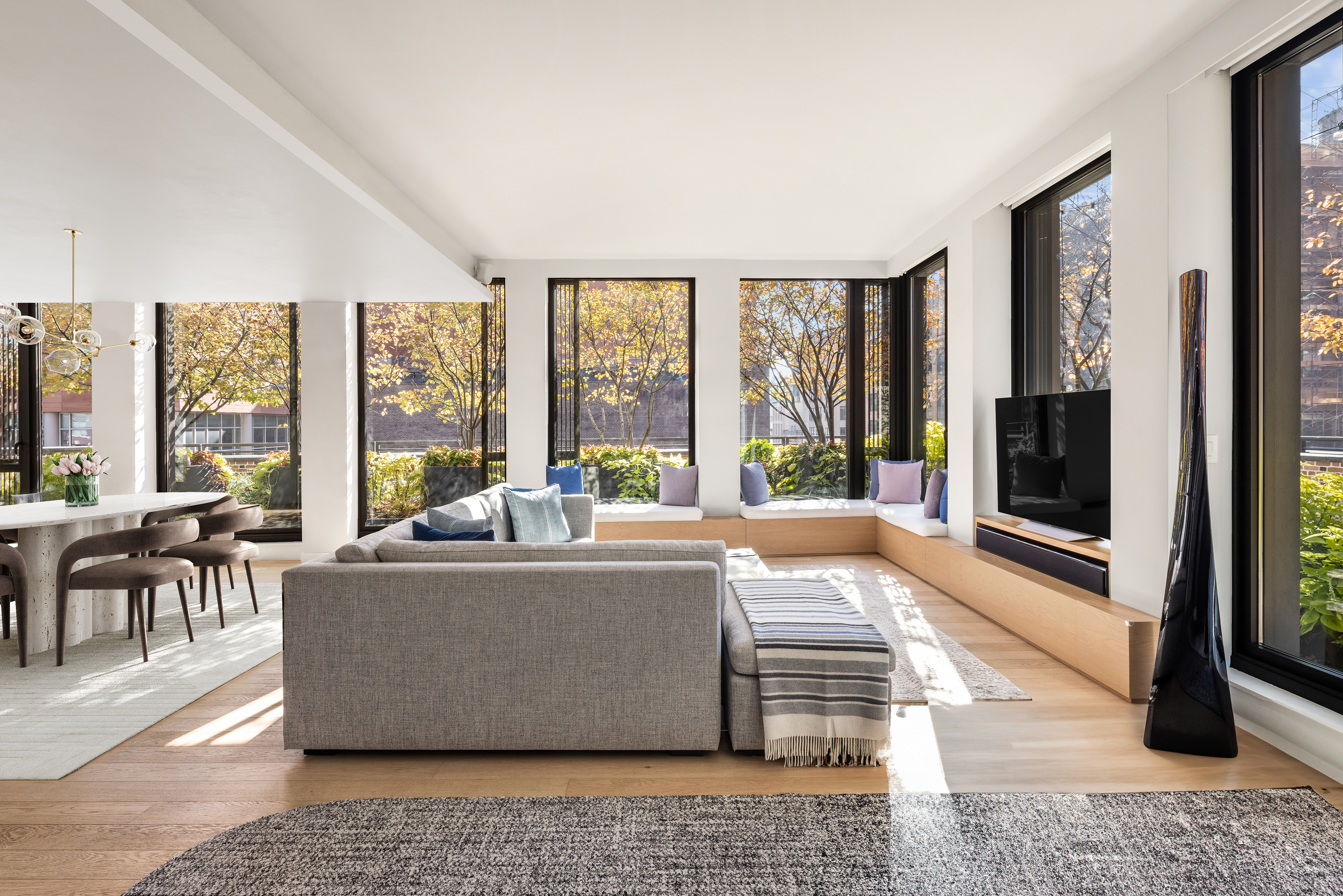 100 Barrow Street, Unit 7/8A Manhattan, NY 10014 - Photo 1 of 23 a living room with large windows and a rug