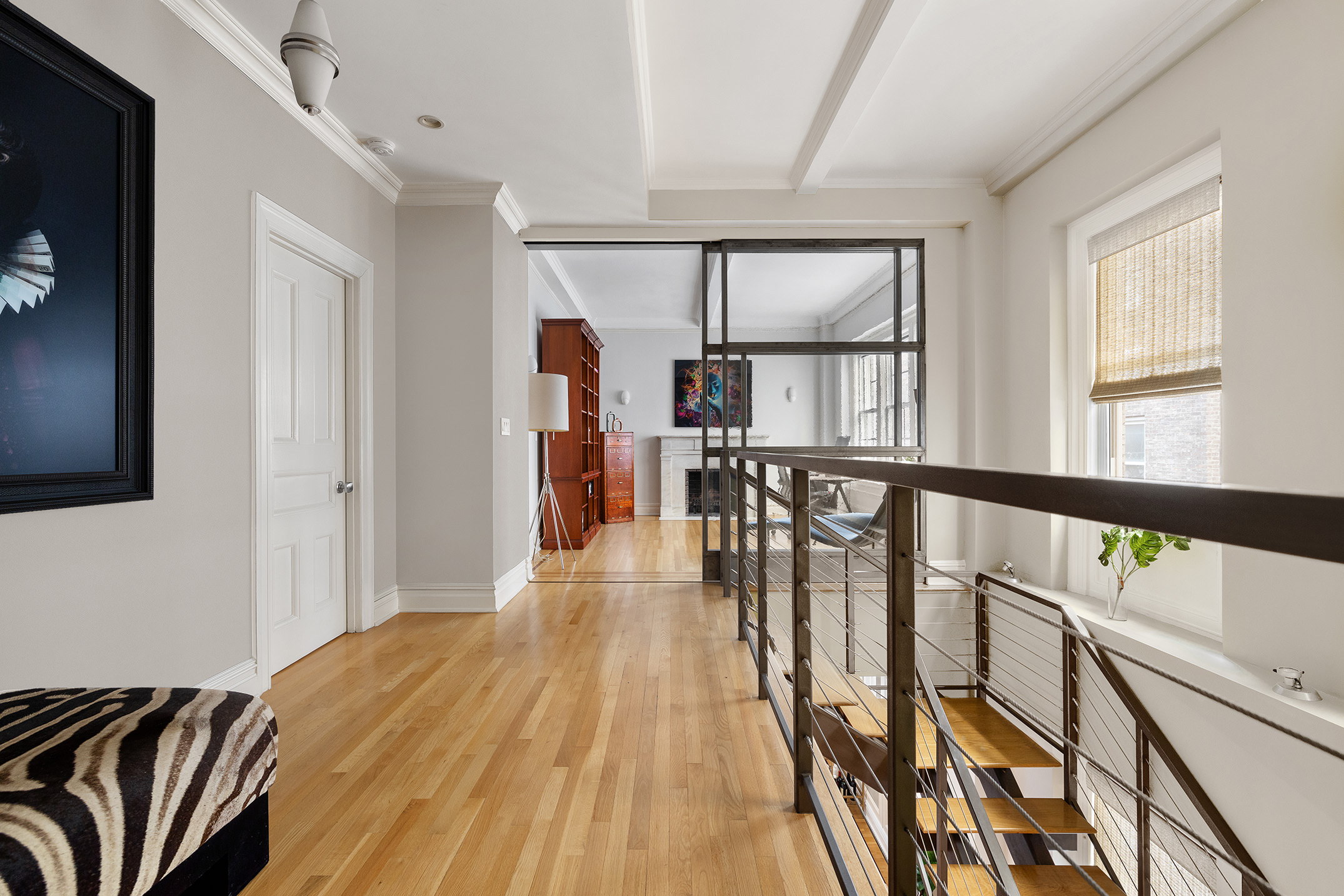 829 Park Avenue, Unit 2D/3D Manhattan, NY 10021 - Photo 8 of 19 a view of a hallway with wooden floor and windows