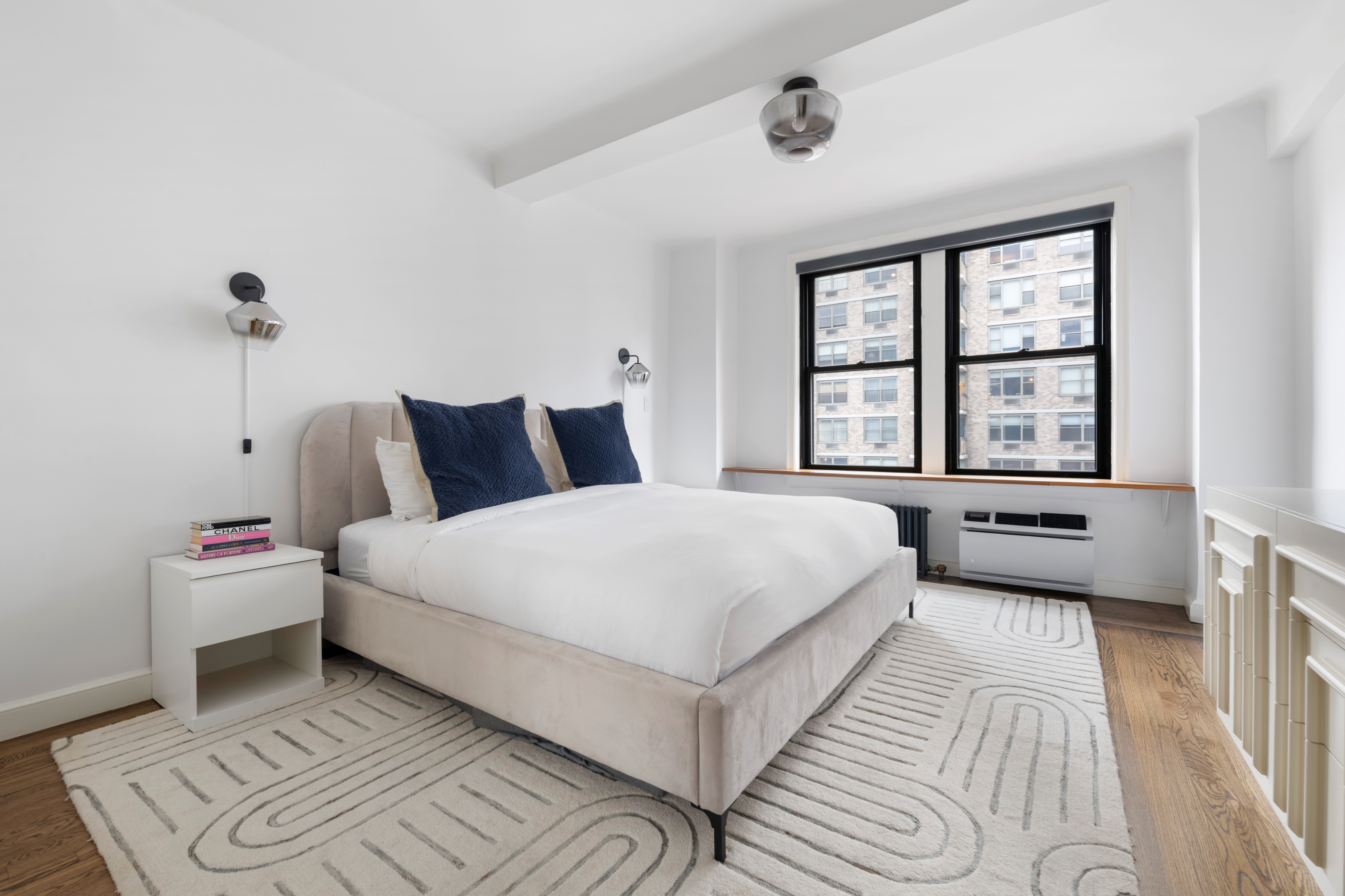 308 East 79th Street, Unit 13EF Manhattan, NY 10075 - Photo 6 of 16 a bedroom with a bed and a large window