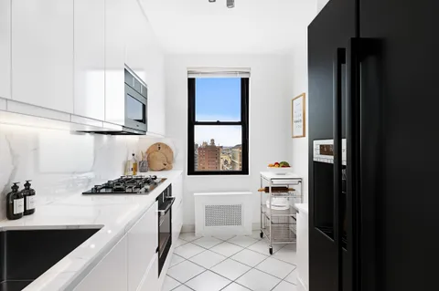 a kitchen with a sink cabinets and appliances