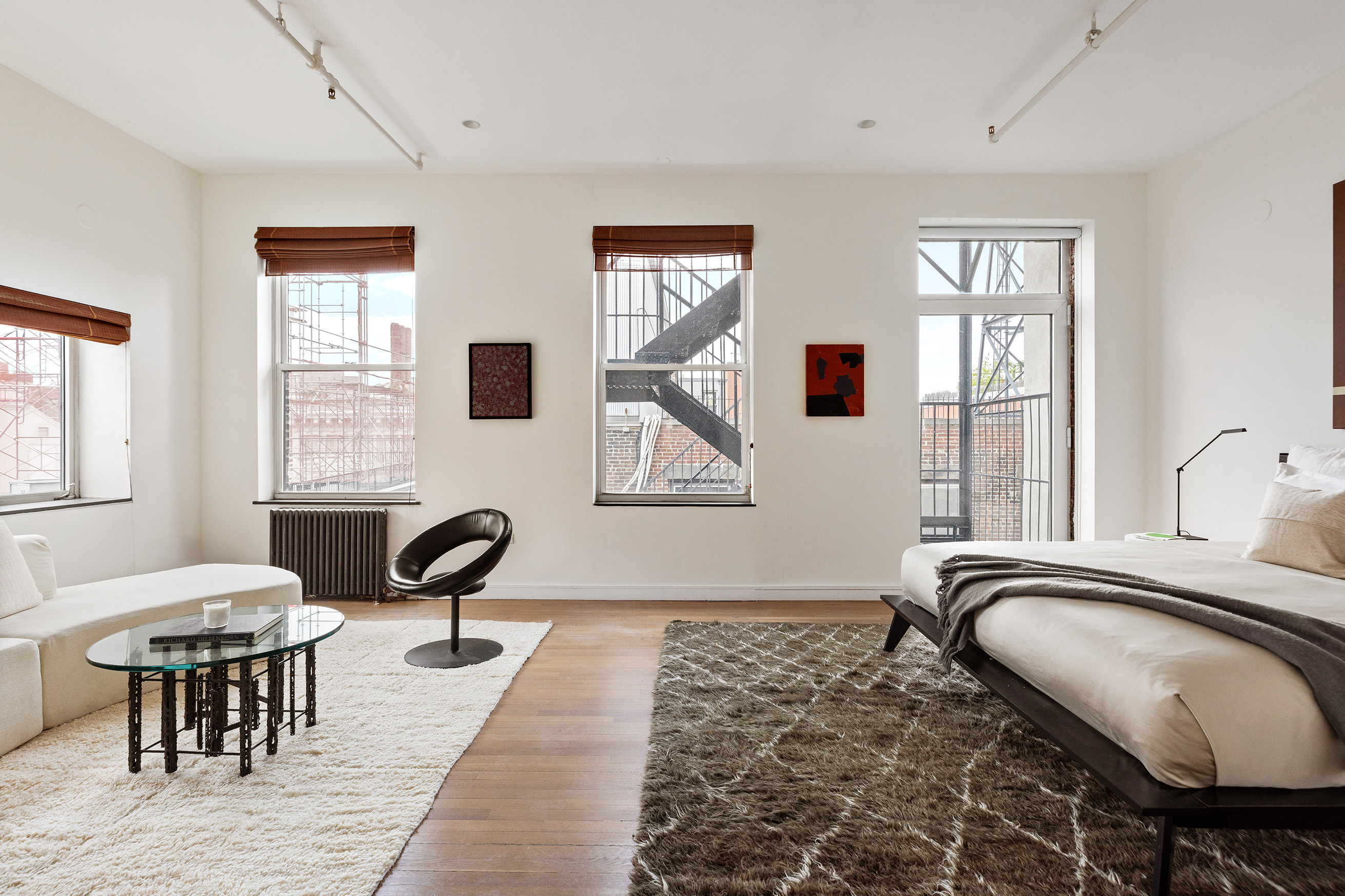 169 Mercer Street, Unit PH Manhattan, NY 10012 - Photo 8 of 15 a bedroom with furniture wooden floor and windows