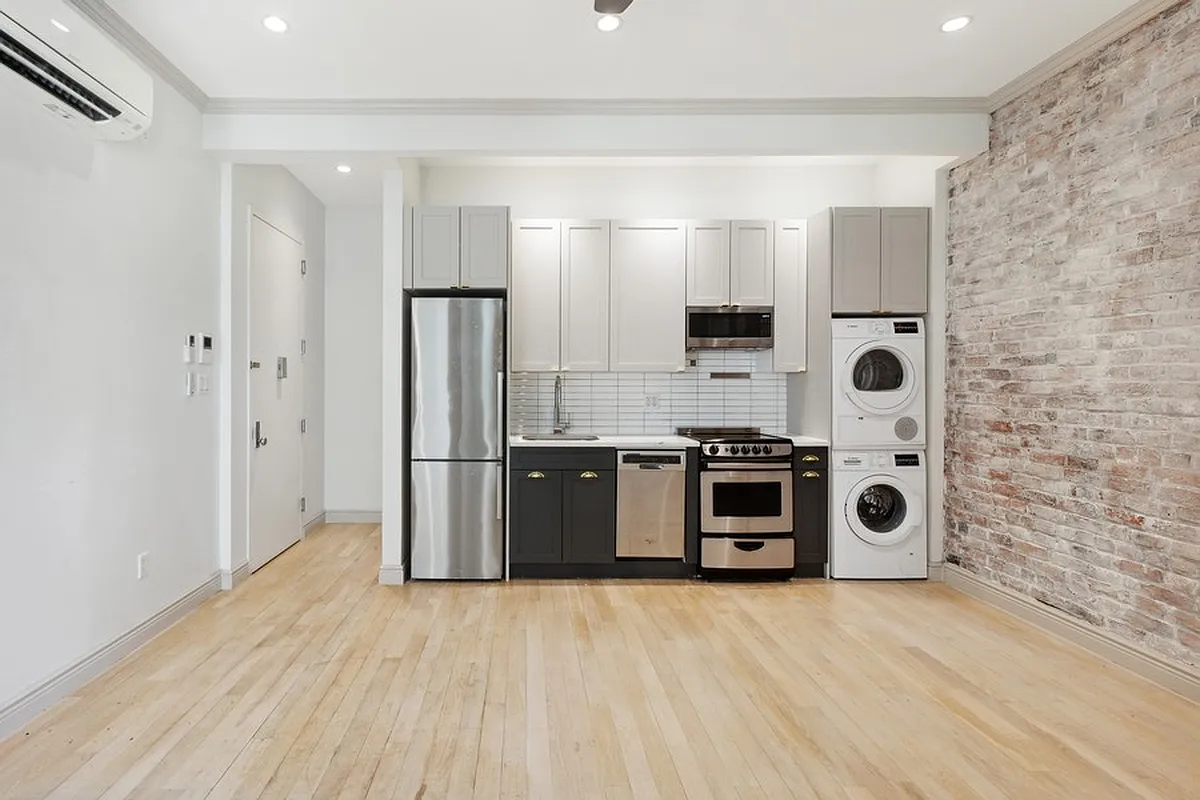 a kitchen with stainless steel appliances granite countertop a refrigerator and a stove