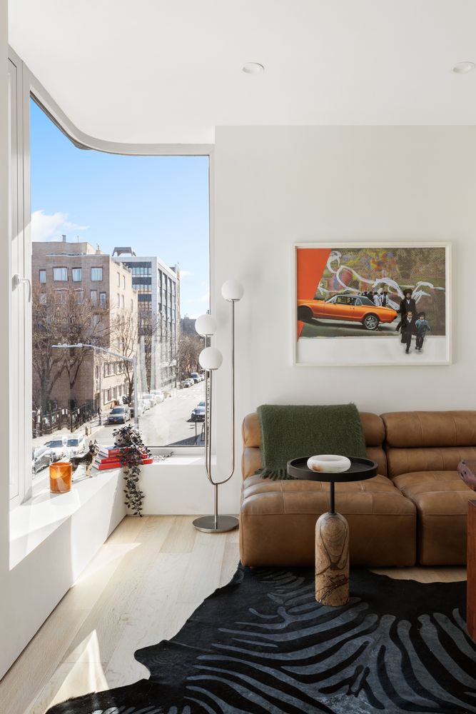 a living room with furniture and a floor to ceiling window