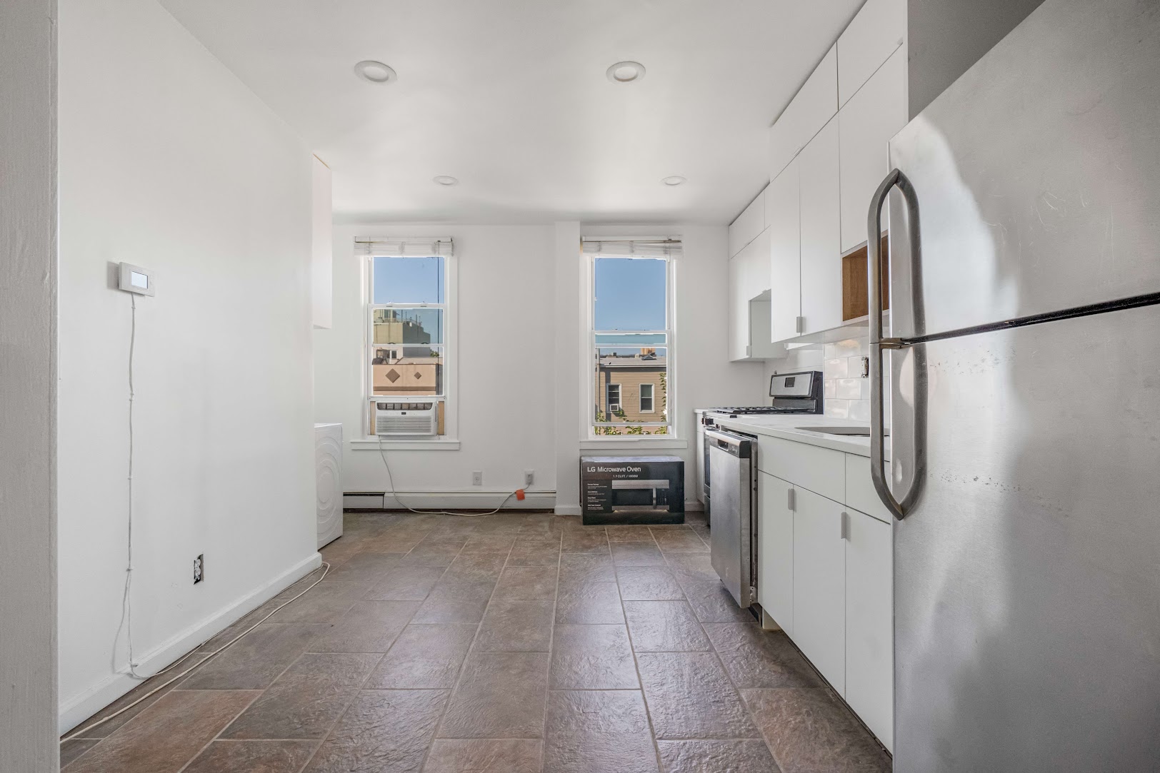 185 A Powers Street, Unit 3 Brooklyn, NY 11211 - Photo 6 of 12 a kitchen with stainless steel appliances a refrigerator and a stove