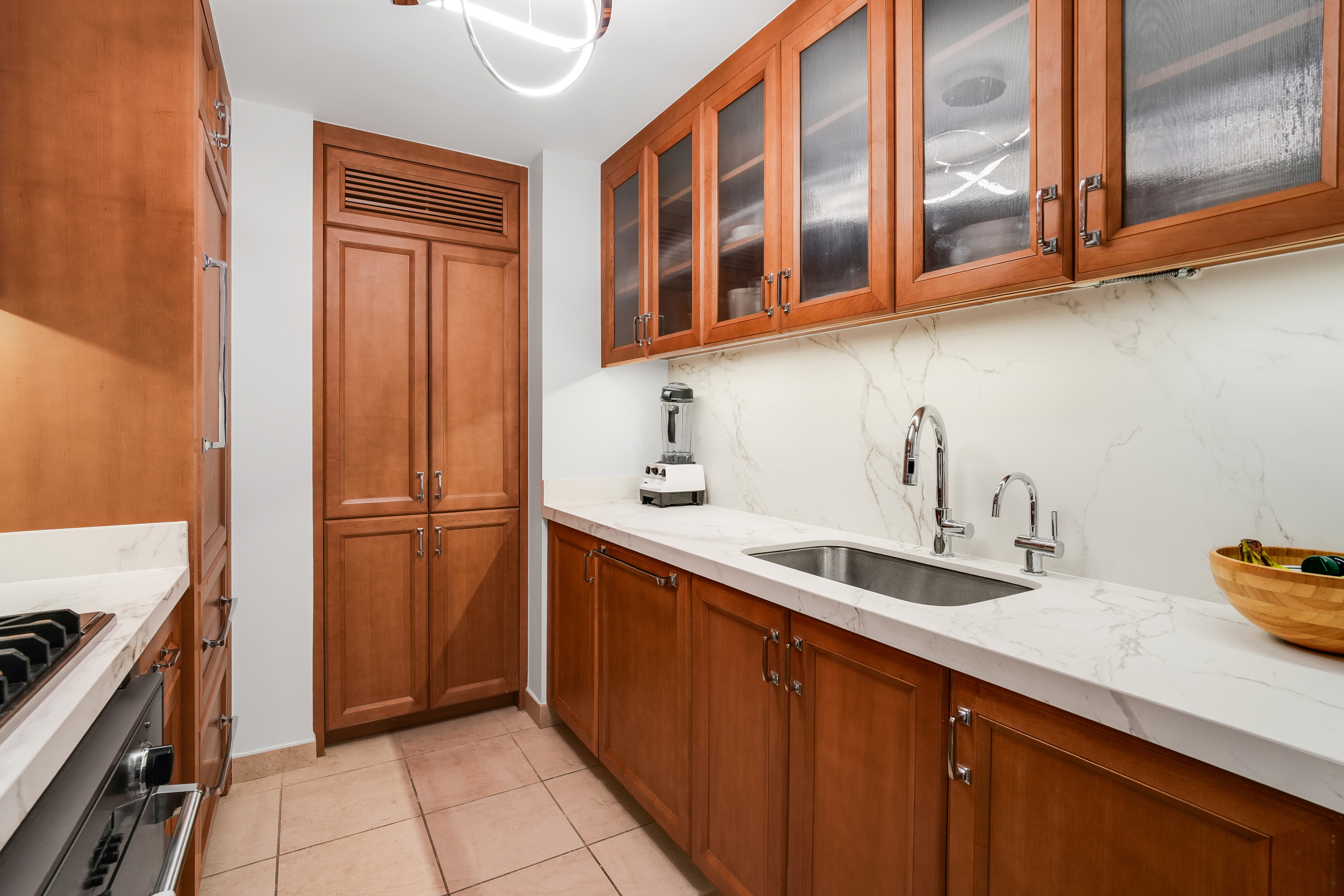 205 East 85th Street, Unit 16H Manhattan, NY 10028 - Photo 3 of 14 a kitchen with stainless steel appliances granite countertop a sink and a cabinets