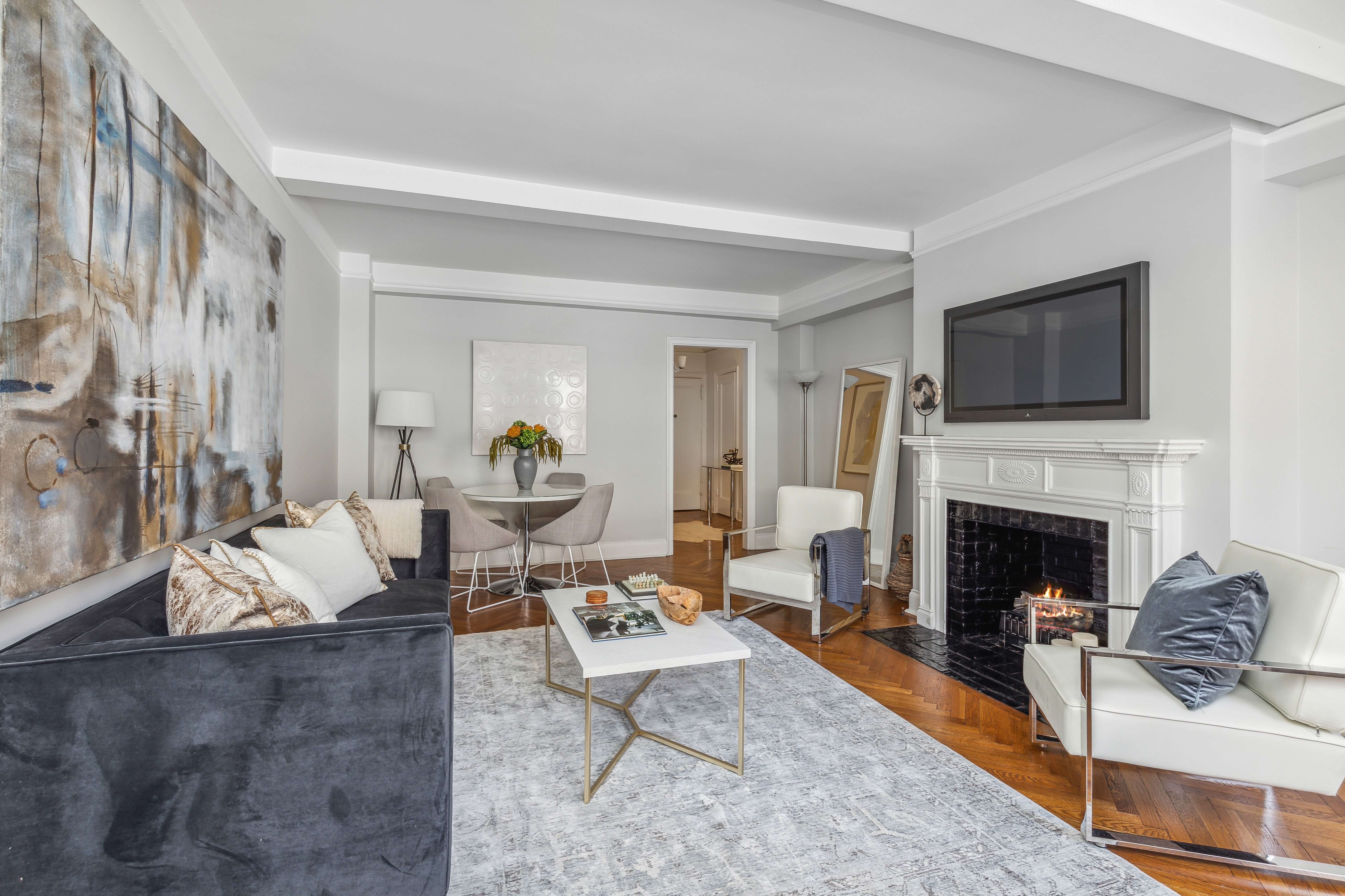 400 East 59th Street, Unit 2D Manhattan, NY 10022 - Photo 2 of 8 a living room with furniture and a fireplace