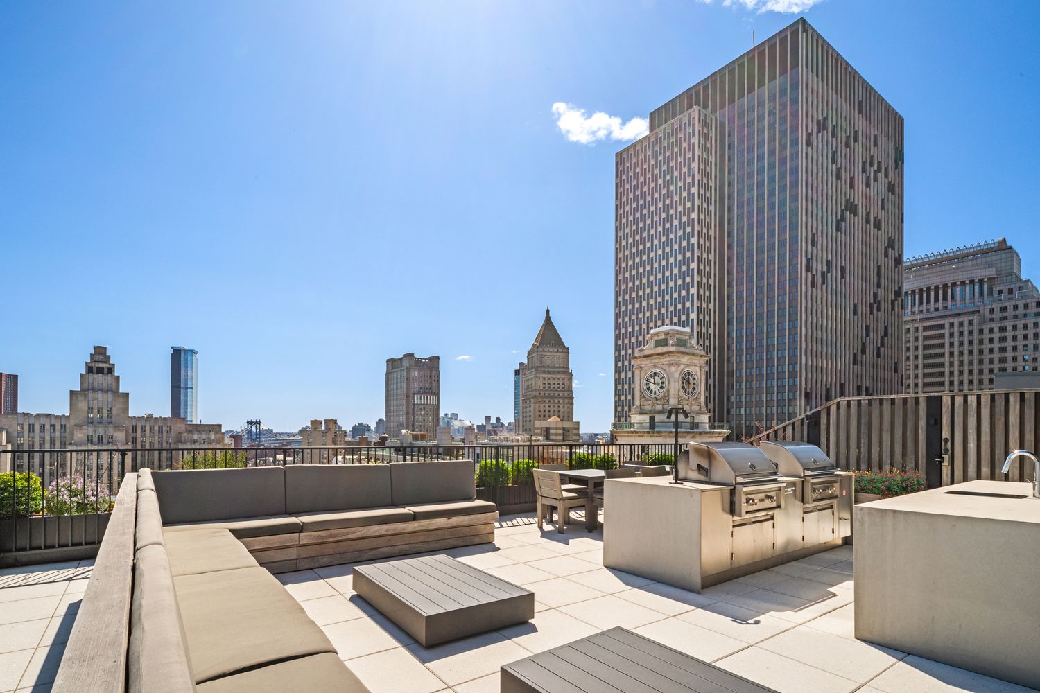 a view of roof deck with couches and wooden floor