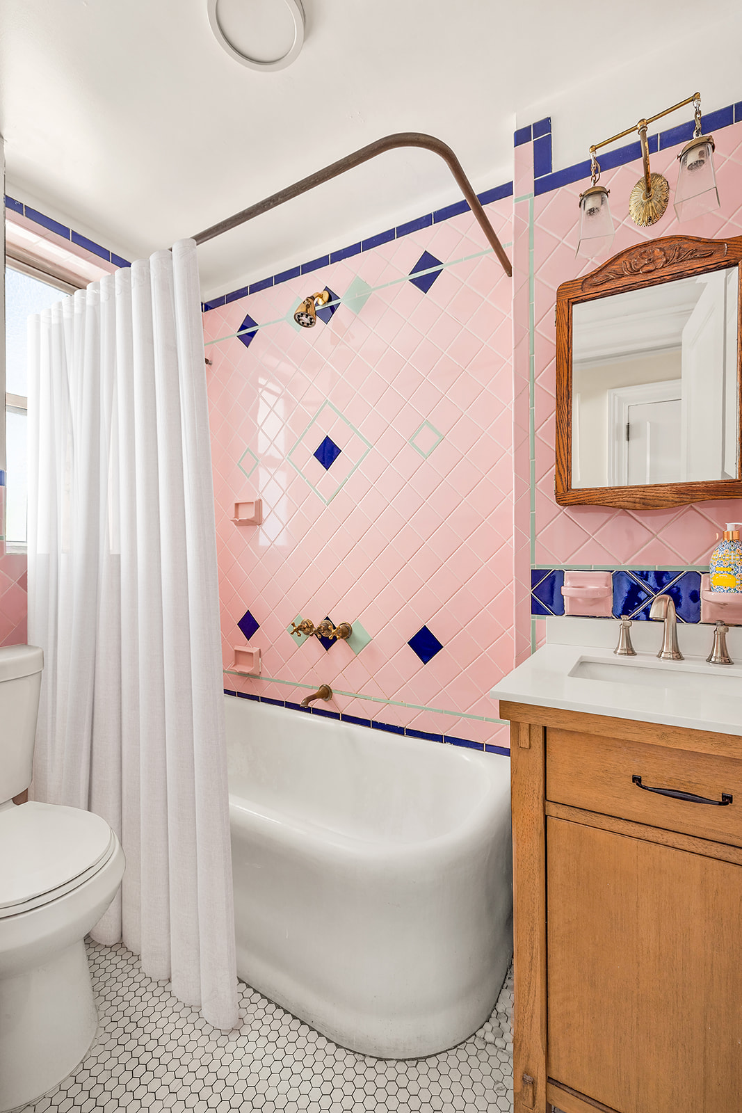 345 West 55th Street, Unit 8AB Manhattan, NY 10019 - Photo 5 of 14 a bathroom with a sink a toilet and a mirror