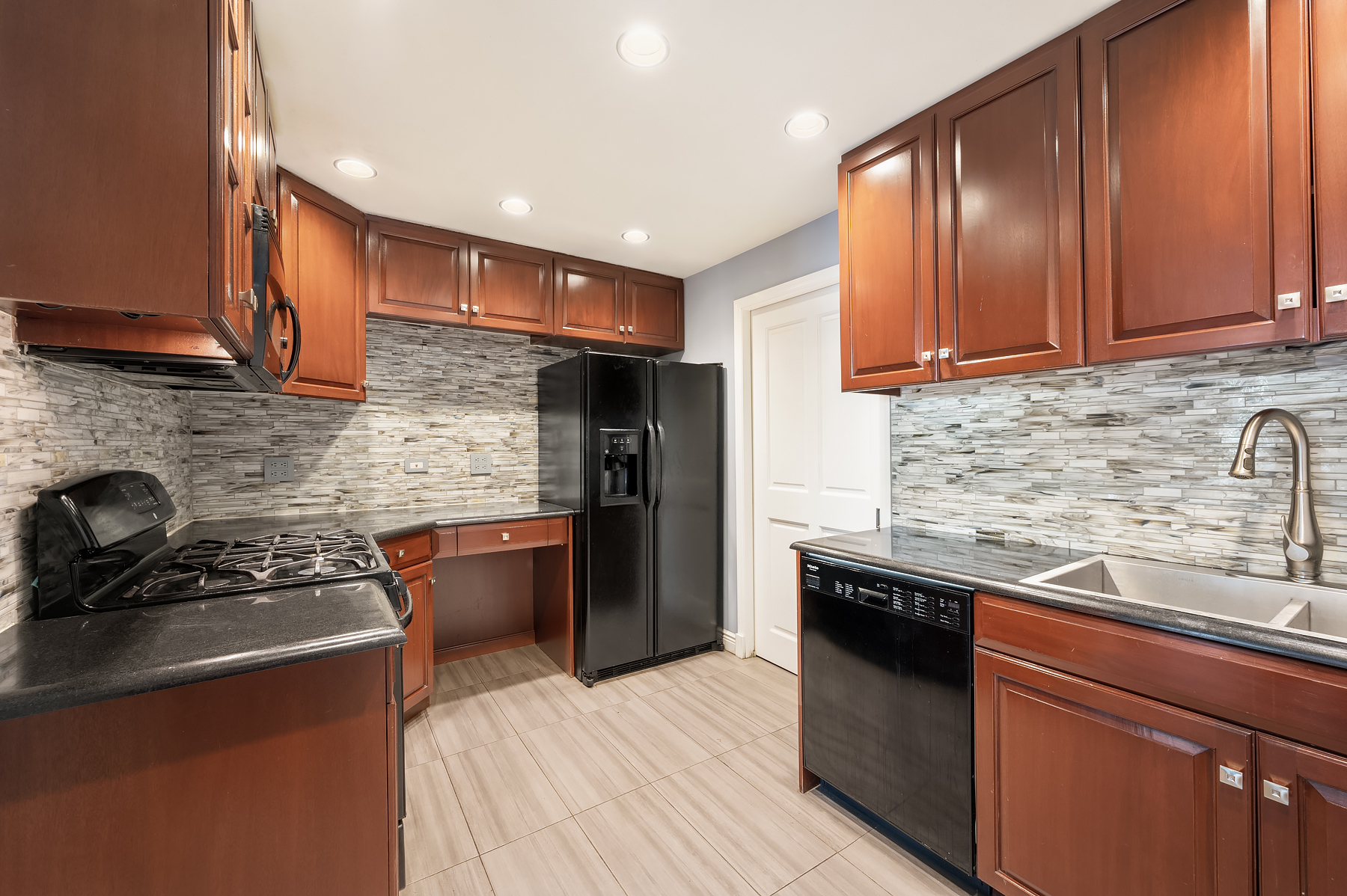 377 Rector Place, Unit 22AB Manhattan, NY 10280 - Photo 2 of 10 a kitchen with stainless steel appliances granite countertop a sink stove and refrigerator