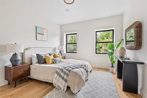 a bedroom with a bed and wooden floor