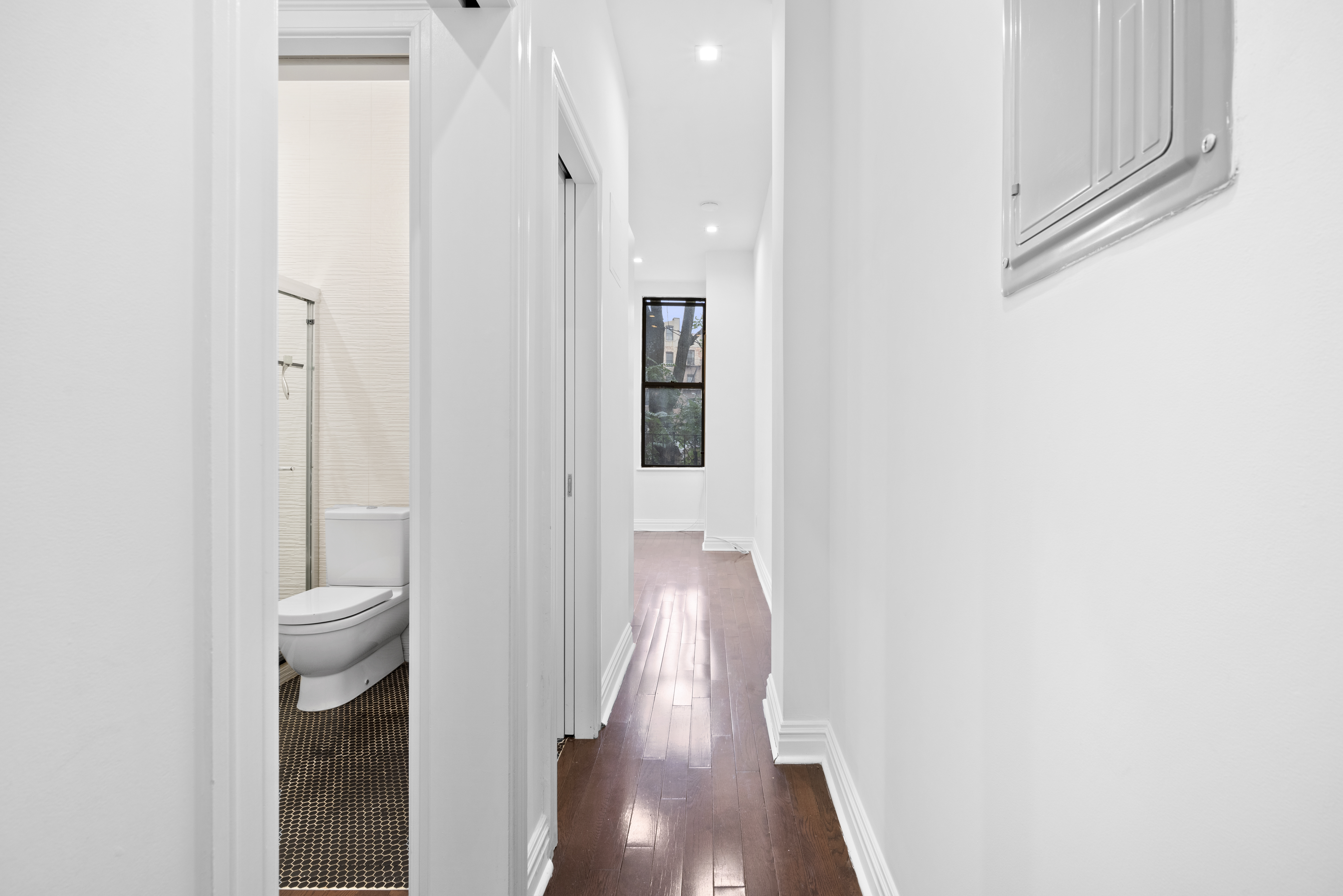 31 St Marks Place, Unit 4 Manhattan, NY 10003 - Photo 9 of 11 a view of a hallway with wooden floor and a bathroom