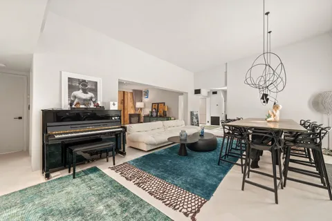 a living room with furniture a rug and a chandelier