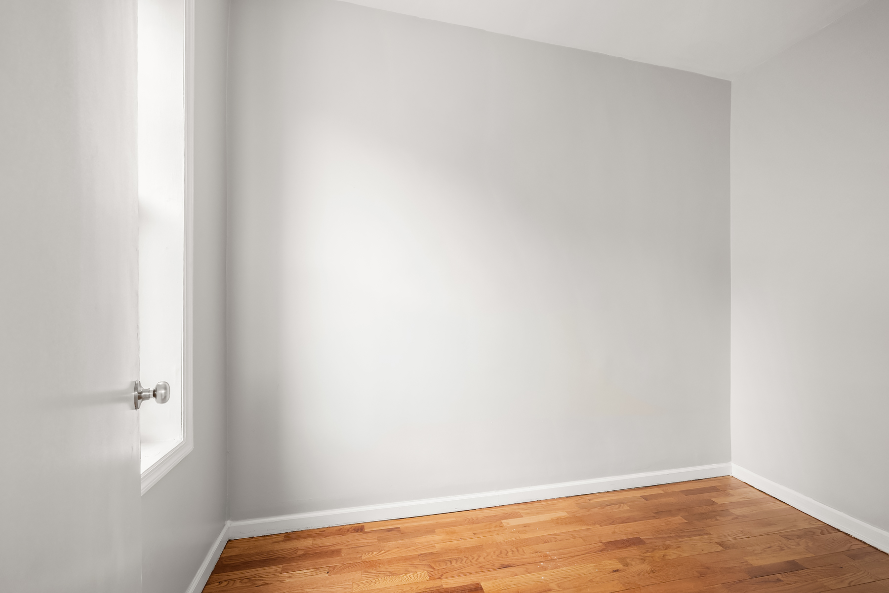 63 East 129th Street, Unit 3 Manhattan, NY 10037 - Photo 3 of 5 a view of a small space with wooden floor