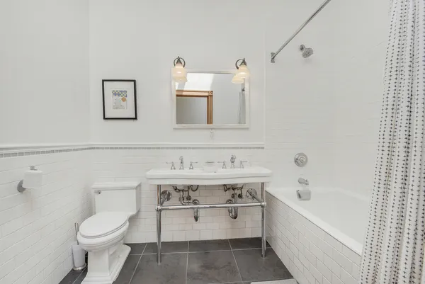 a bathroom with a sink a toilet and bathtub