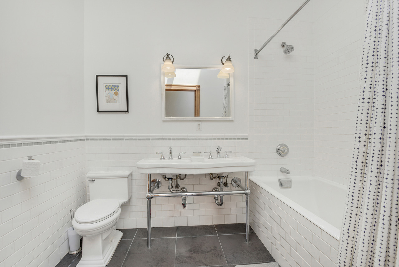 347 West 121st Street Manhattan, NY 10027 - Photo 10 of 16 a bathroom with a sink a toilet and bathtub