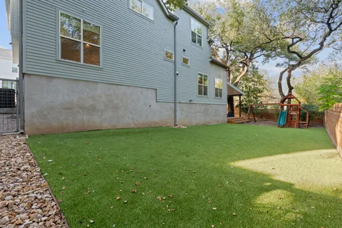 a view of a backyard with large trees
