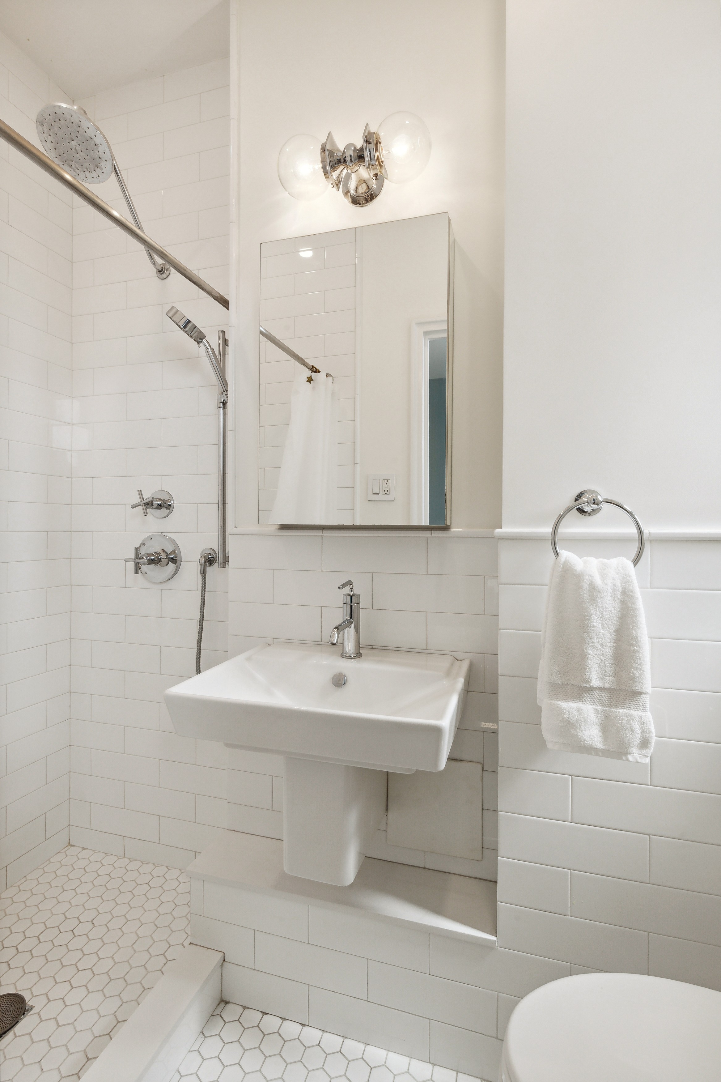 158-18 Riverside Drive West, Unit 2E Manhattan, NY 10032 - Photo 7 of 22 a bathroom with a sink toilet and shower
