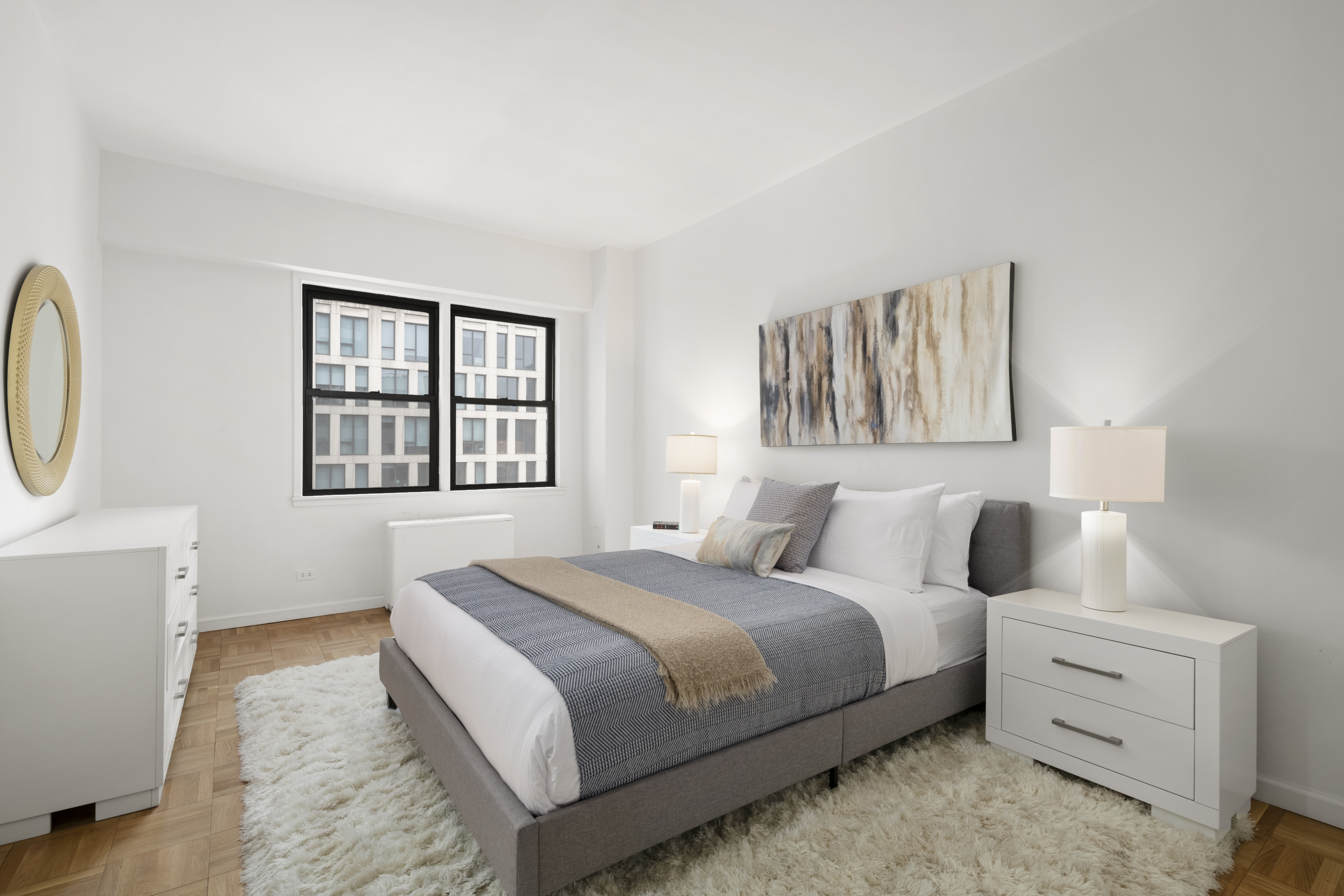 201 East 21st Street, Unit 15C Manhattan, NY 10010 - Photo 6 of 9 a bedroom with a bed and a dresser