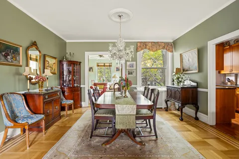 a dining room with furniture a chandelier and window