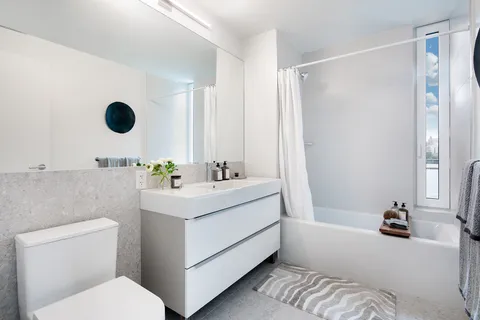 a bathroom with a sink mirror vanity and toilet