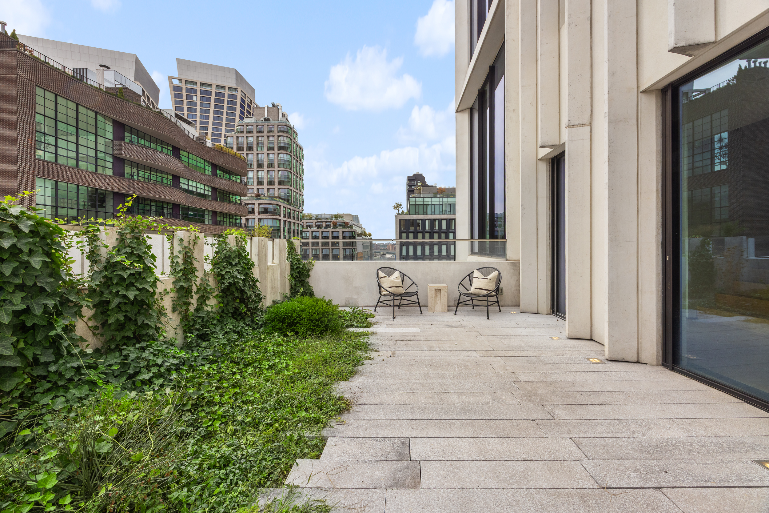 455 West 19th Street, Unit PH2 Manhattan, NY 10011 - Photo 4 of 26 a view of a patio with couches and potted plants