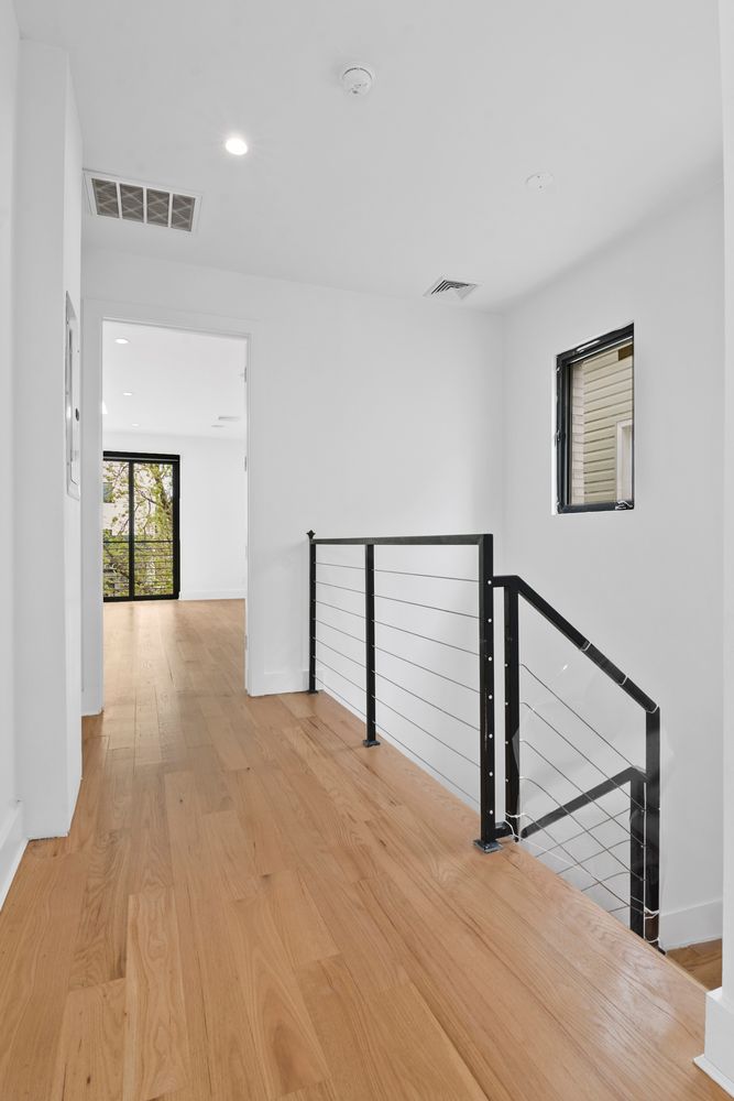 296 Fenimore Street Brooklyn, NY 11225 - Photo 7 of 19 a view of an empty room with wooden floor and a window
