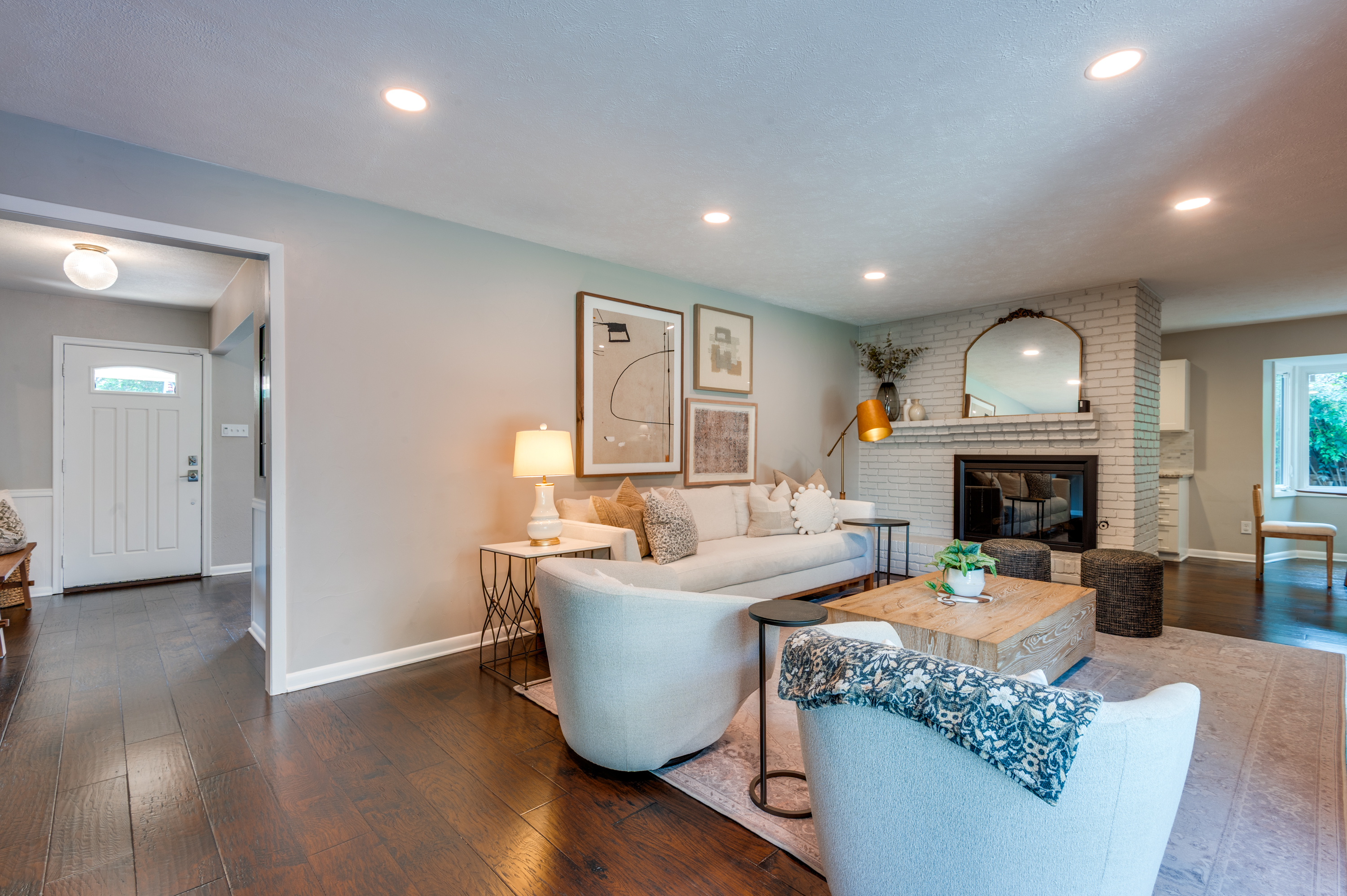 3363 Merrell Road Dallas, TX 75229 - Photo 5 of 29 a living room with furniture a fireplace and a chandelier