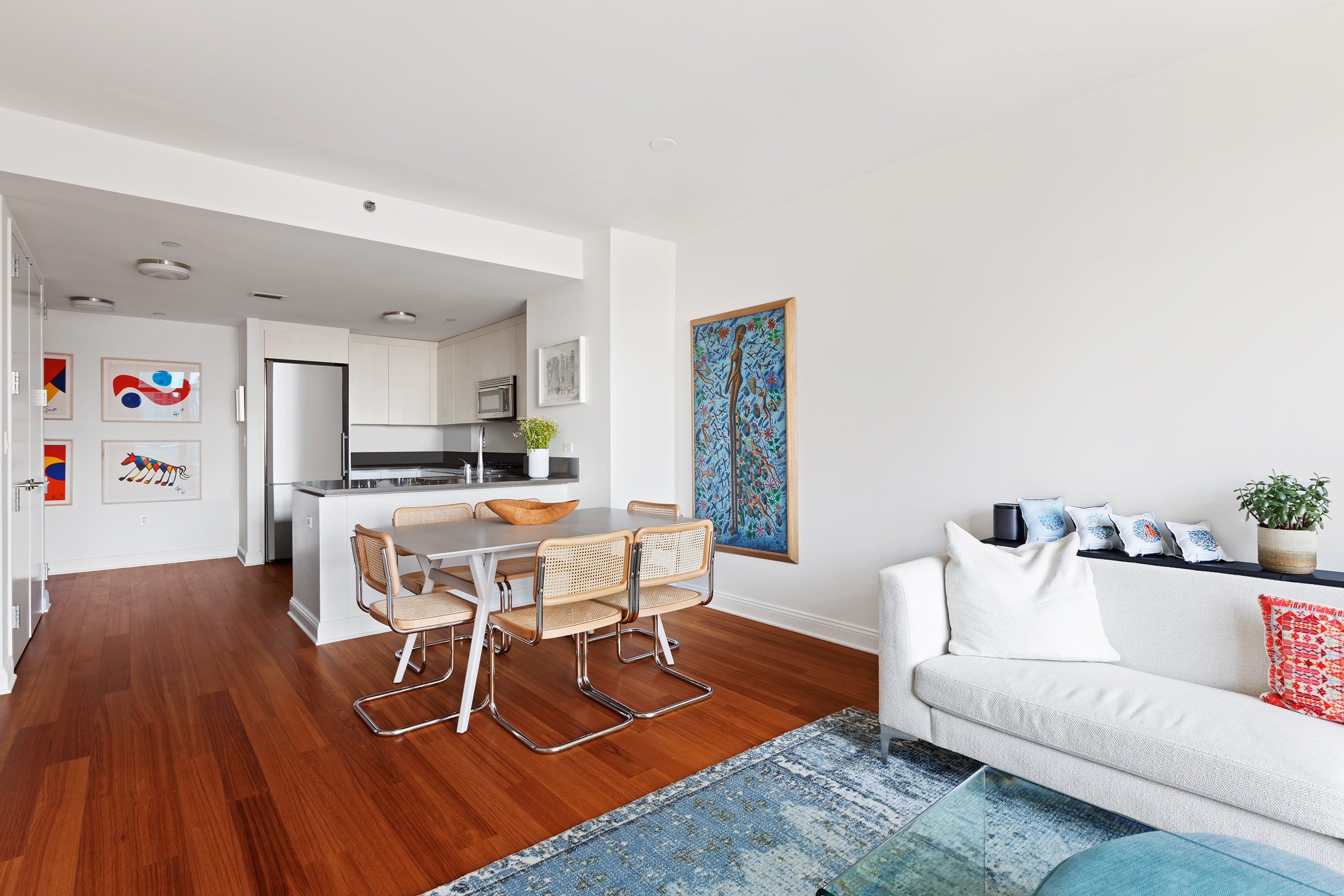 57 Reade Street, Unit 14C Manhattan, NY 10007 - Photo 5 of 16 a living room with furniture and a dining table with wooden floor