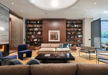 a living room with furniture and a chandelier