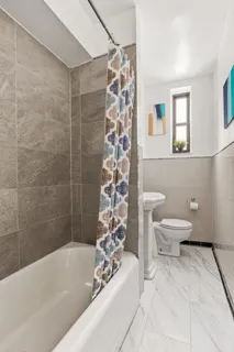 a bathroom with a bathtub and shower