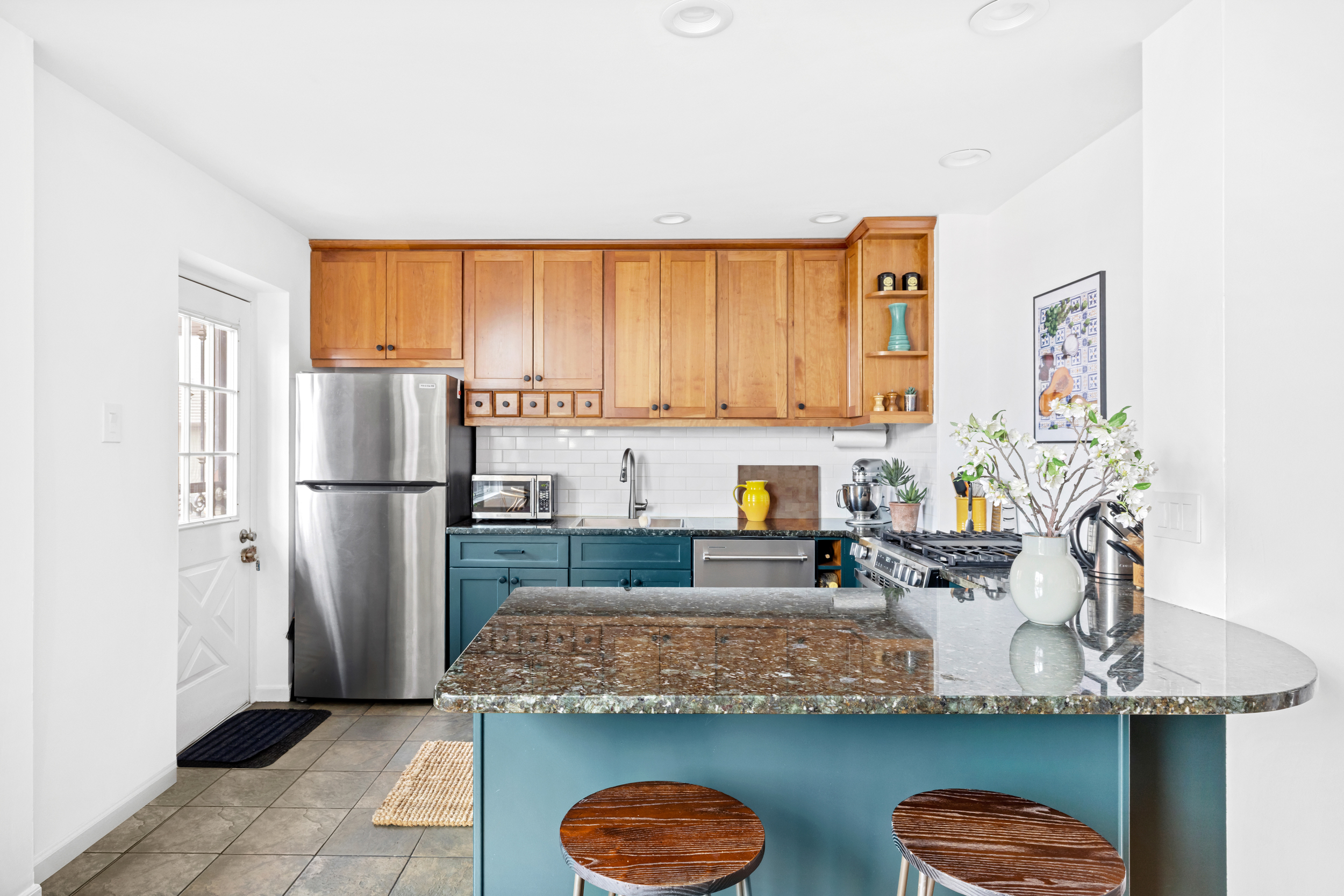 31 1st Place, Unit 3 Brooklyn, NY 11231 - Photo 4 of 11 a kitchen with granite countertop a refrigerator a stove a microwave and island