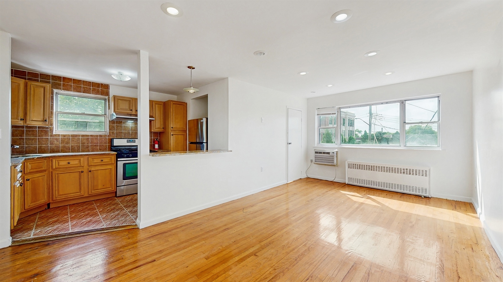 a view of a kitchen with large windows