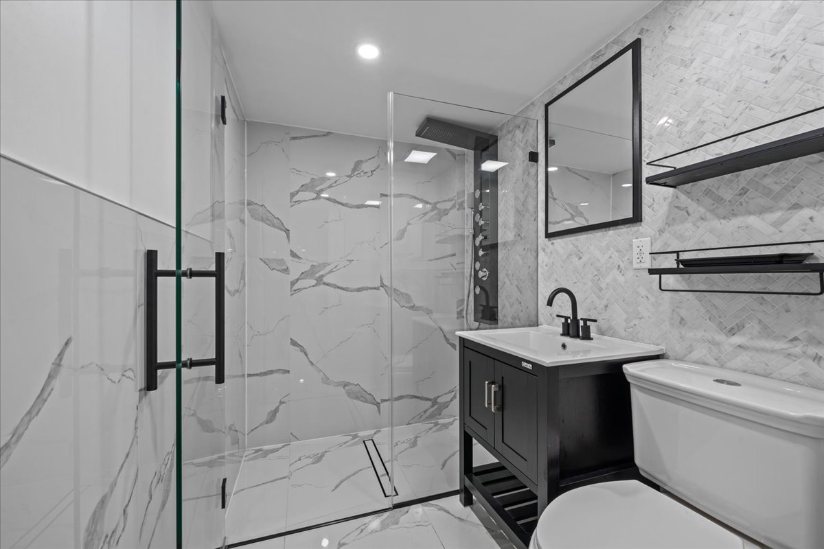 581 Decatur Street Brooklyn, NY 11233 - Photo 14 of 22 a bathroom with a sink toilet and shower