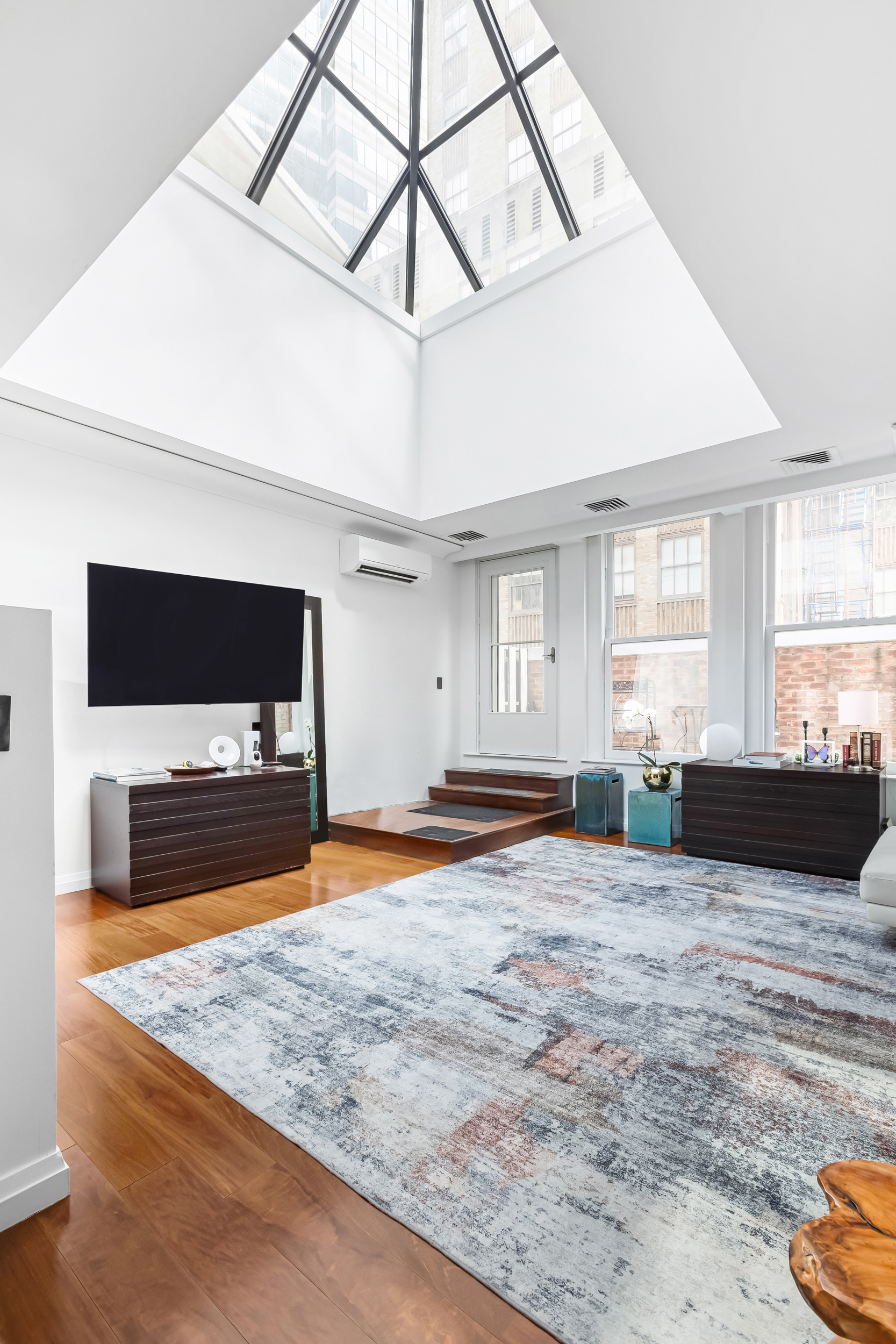 55 Wall Street, Unit PH942 Manhattan, NY 10005 - Photo 2 of 9 a view of livingroom with furniture and window