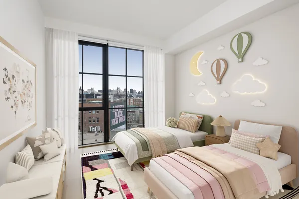 a bedroom with two beds and a large window