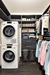 a view of walk in closet with clothes and shoes