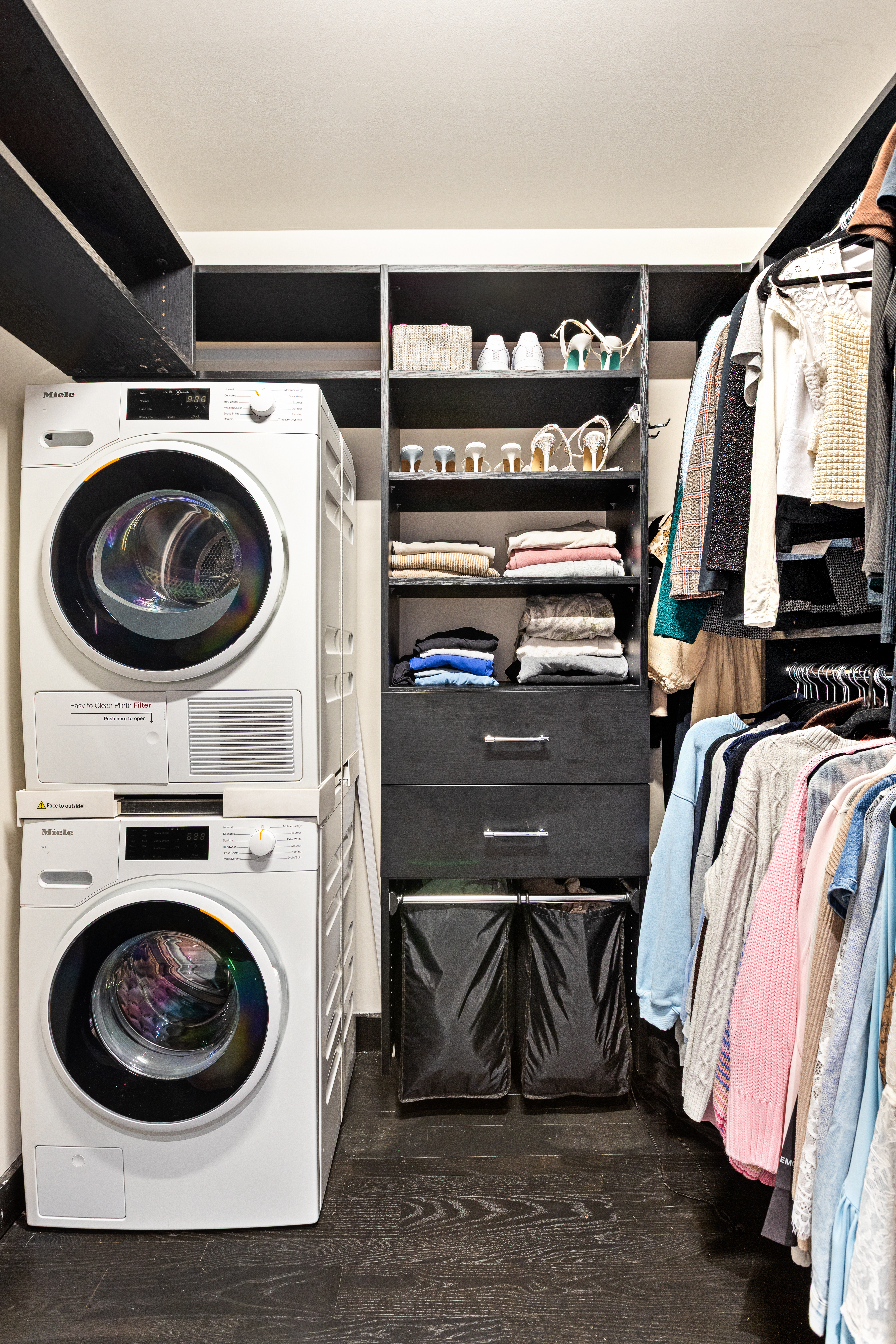 20 Pine Street, Unit 1205 Manhattan, NY 10005 - Photo 10 of 17 a view of walk in closet with clothes and shoes