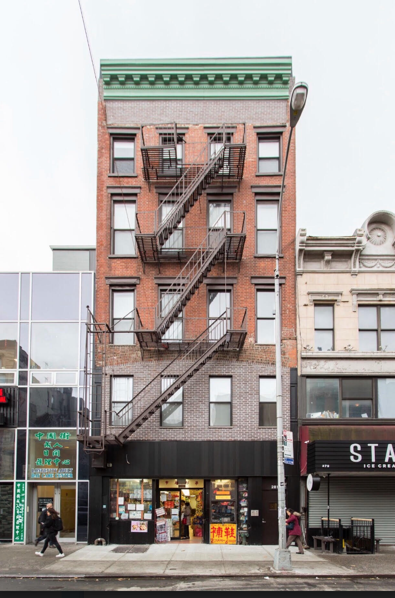 281 Grand Street, Unit 2R Manhattan, NY 10002 - Photo 5 of 5 a front view of a building with street