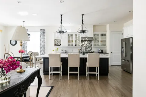 a dining room with stainless steel appliances kitchen island granite countertop furniture and a kitchen view
