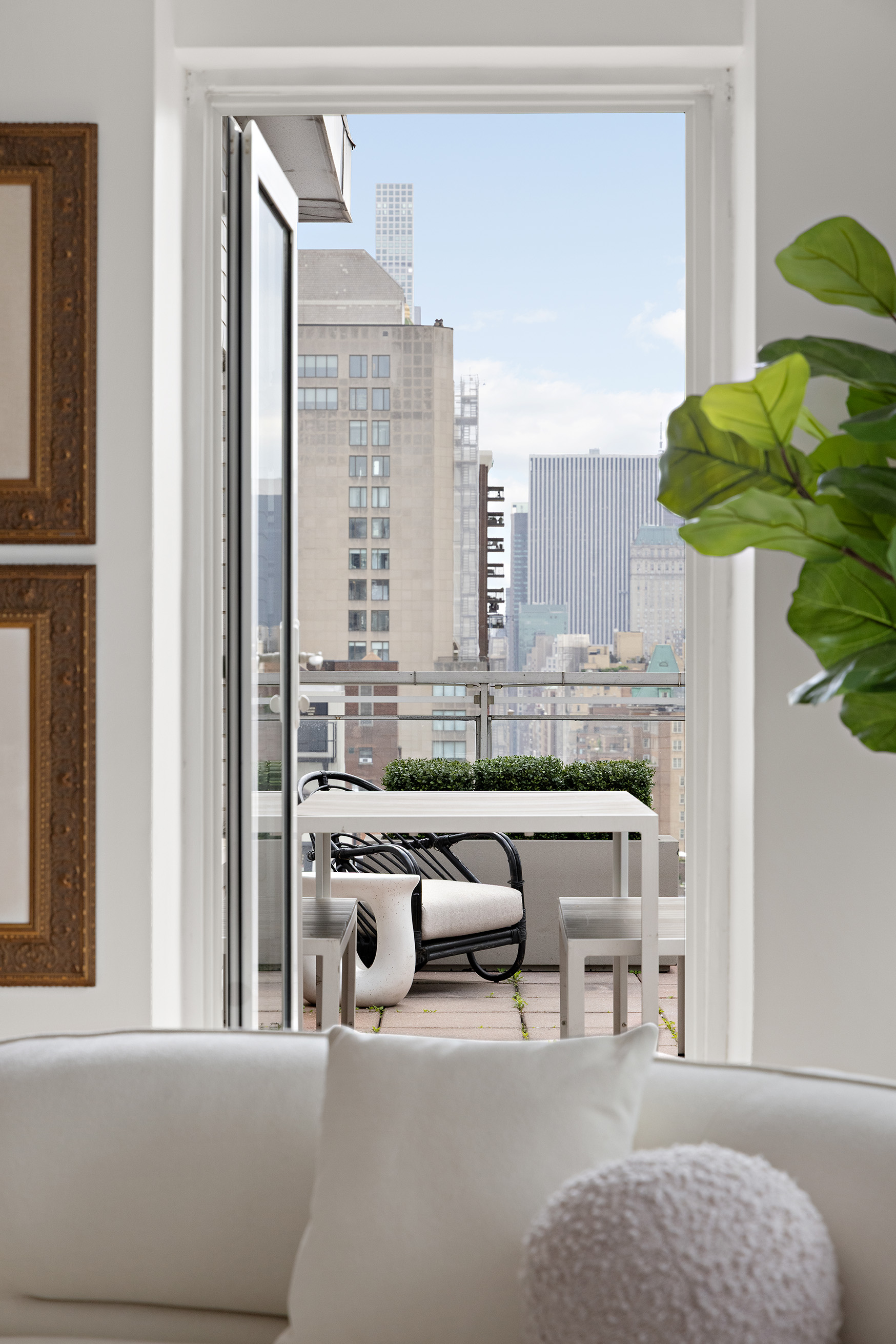 40 East 84th Street, Unit 17A Manhattan, NY 10028 - Photo 5 of 16 a living room with furniture and a potted plant