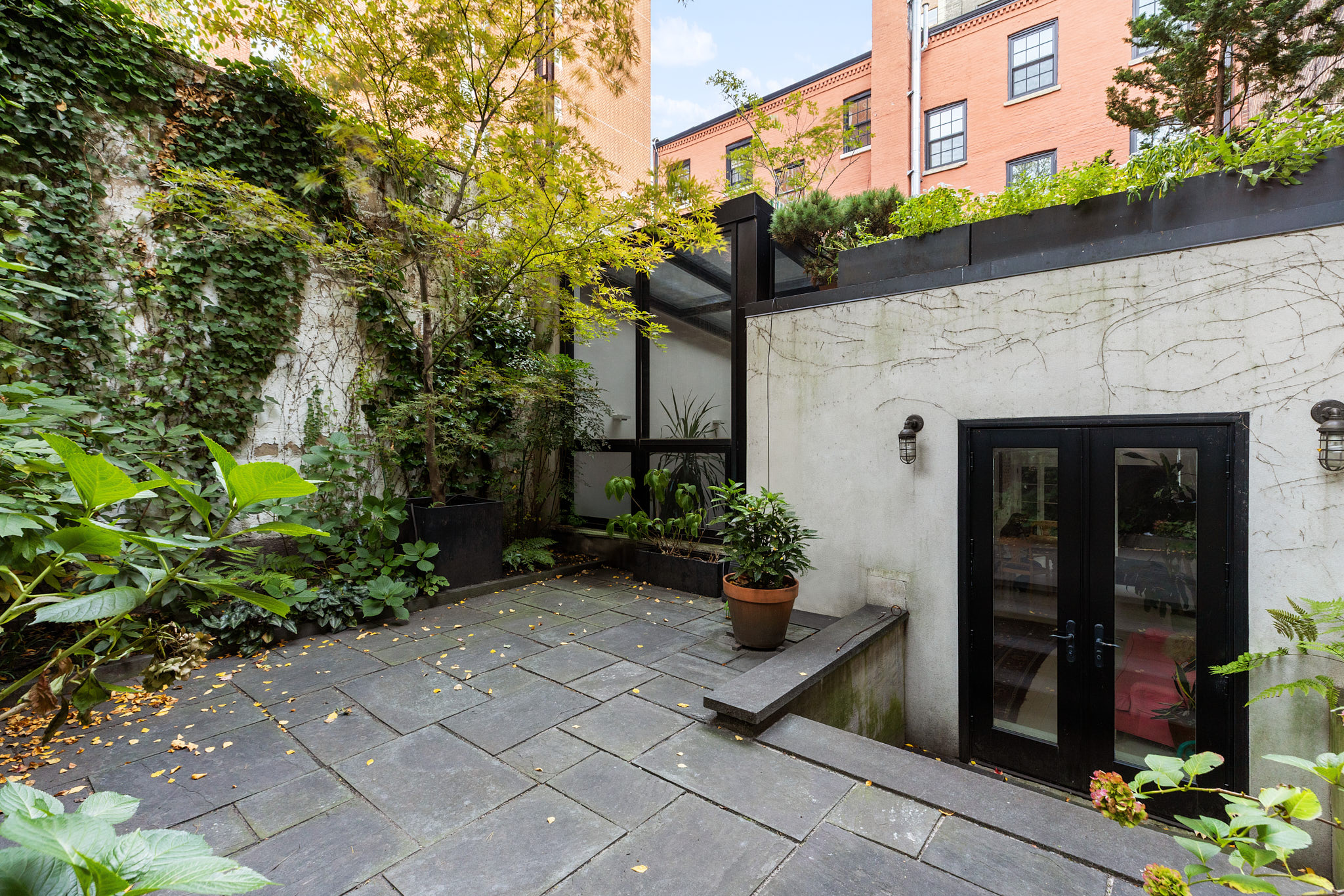 13 Vandam Street Manhattan, NY 10014 - Photo 21 of 26 a front view of a house with plants