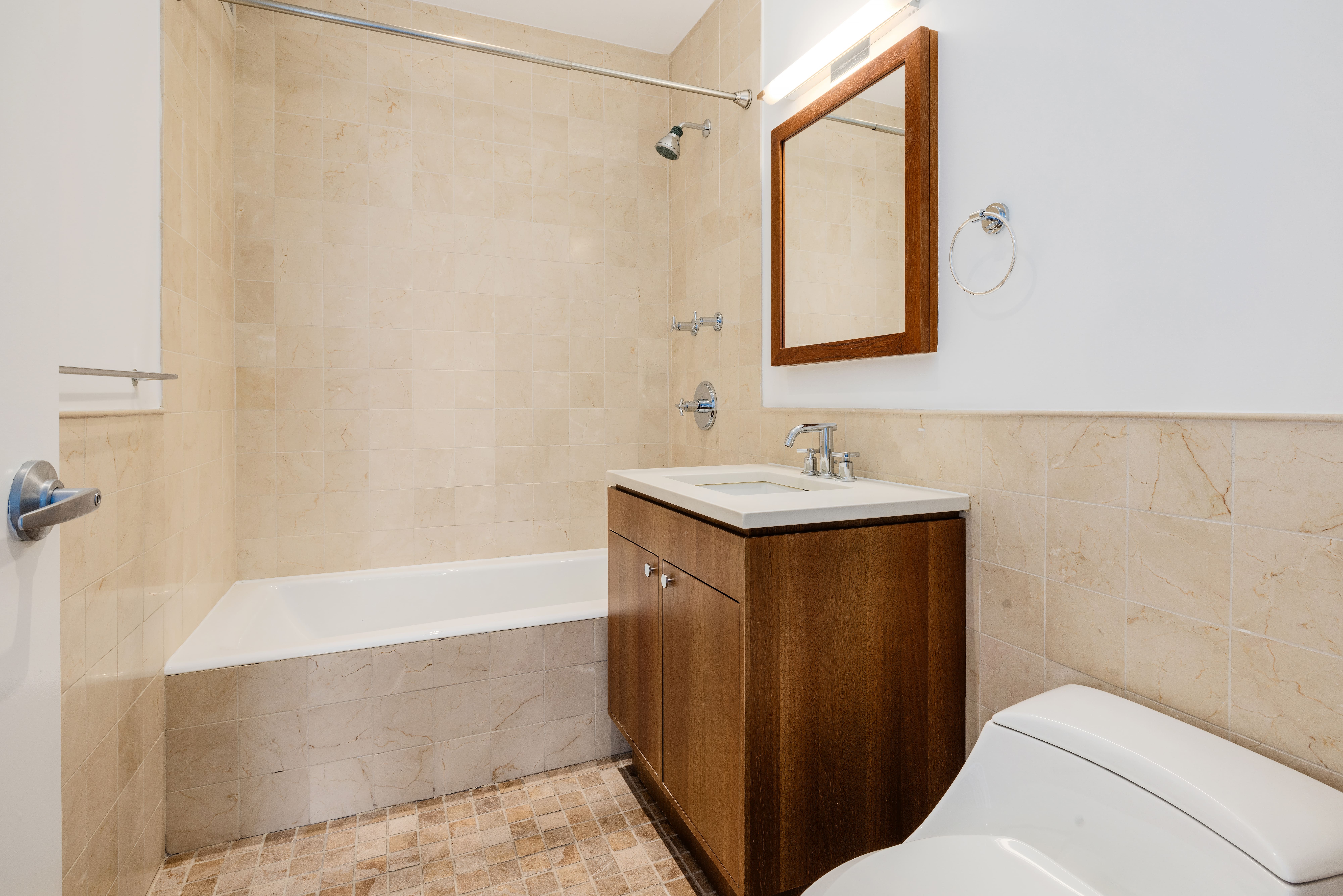 10 West End Avenue, Unit 21D Manhattan, NY 10023 - Photo 9 of 13 a bathroom with a sink and a mirror