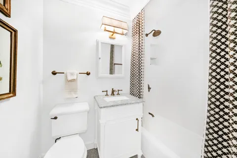 a bathroom with a sink a toilet and a mirror