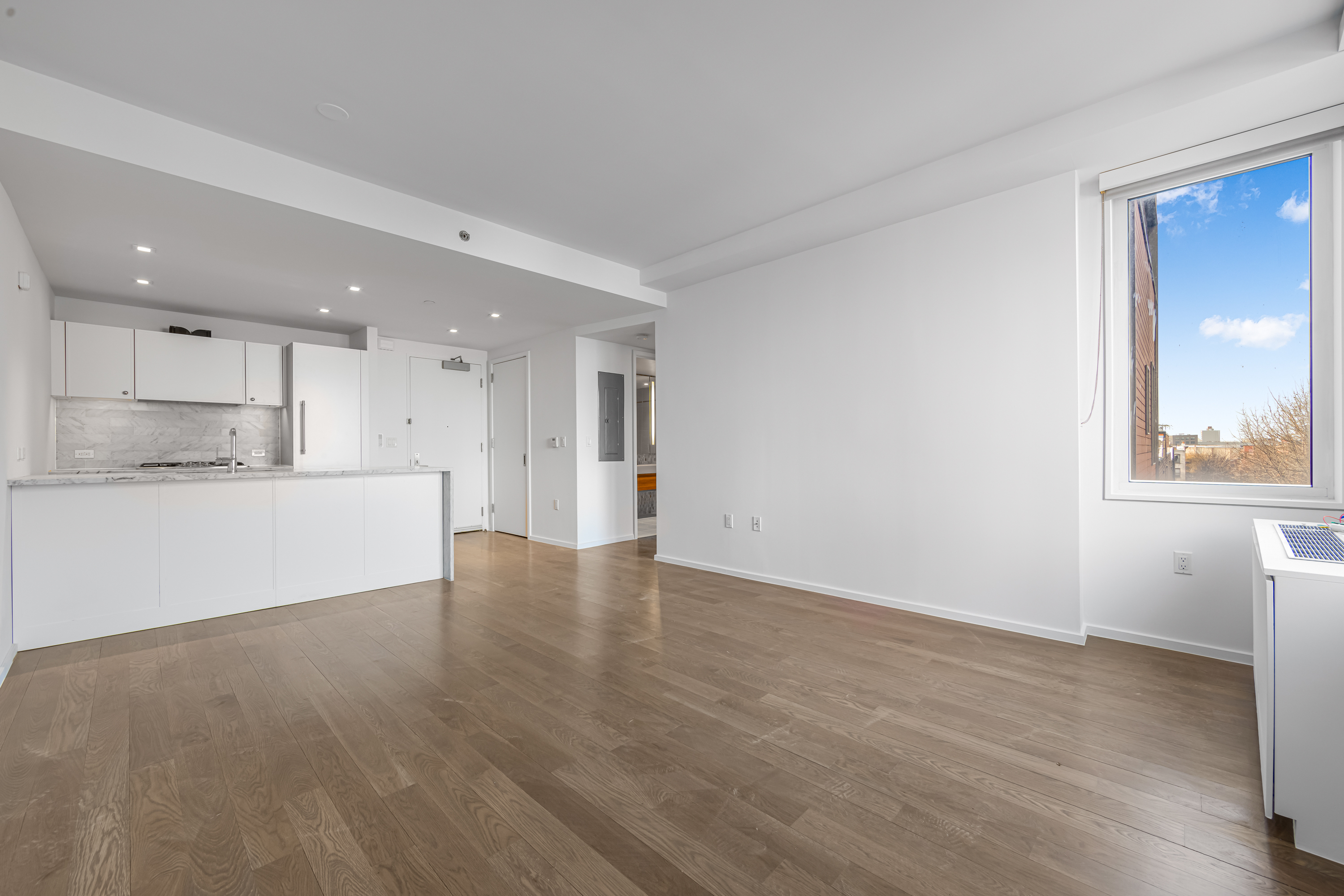 202 8th Street, Unit 4E Brooklyn, NY 11215 - Photo 7 of 19 a view of an empty room with wooden floor and a window