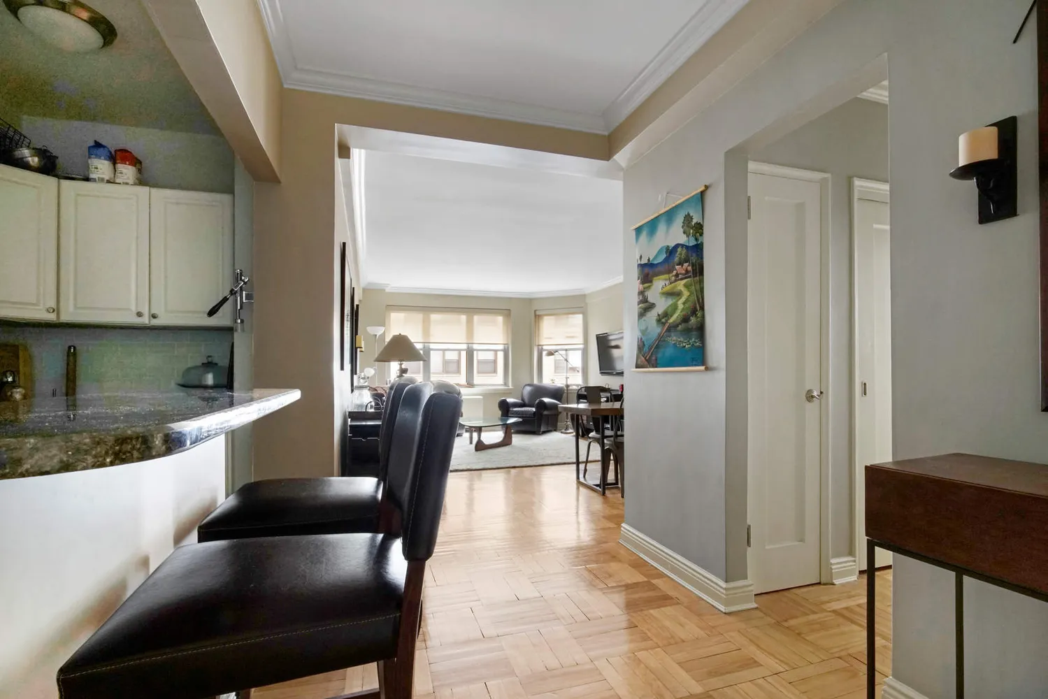 a living room with furniture and a kitchen