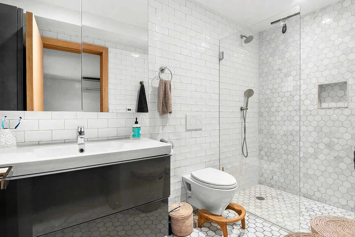 87 Monroe Street, Unit 1 Brooklyn, NY 11216 - Photo 7 of 11 a bathroom with a sink toilet and shower