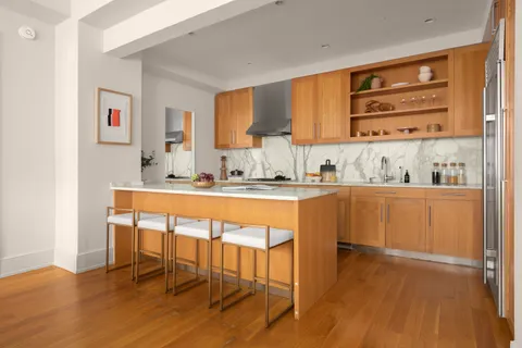 a kitchen with a sink cabinets and wooden floor
