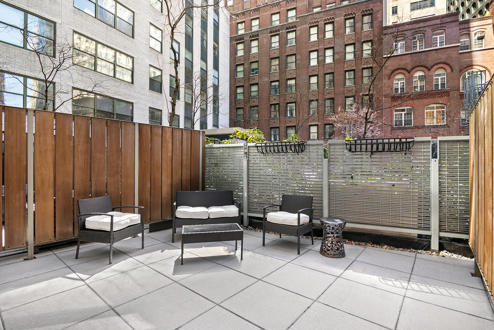 99 John Street, Unit 522 Manhattan, NY 10038 - Photo 2 of 11 a backyard of a residential building with barbeque oven and outdoor seating